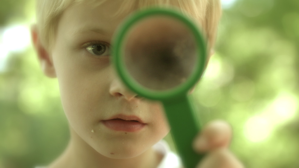 Kind mit Lupe